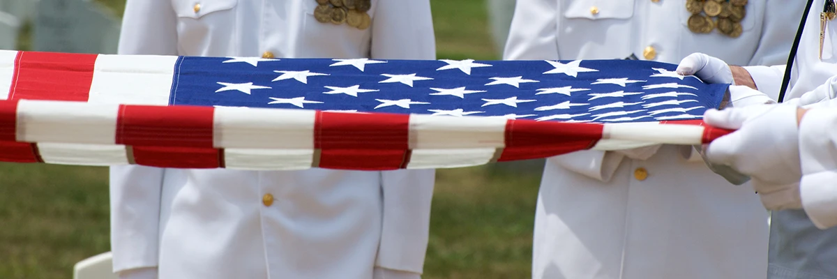 military funeral uniformed men folding American flag