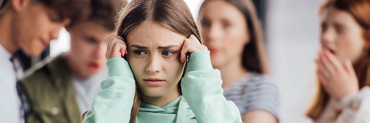 young girl suffering from anxiety when being bullied at school